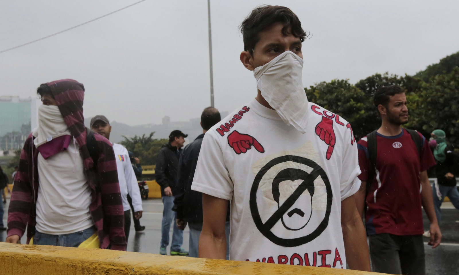 A demonstrator eyes a cordon of Bolivarian National Guard soldiers during an anti-government protest in Caracas, Venezuela, Thursday, April 13, 2017.  (AP/Fernando Llano)