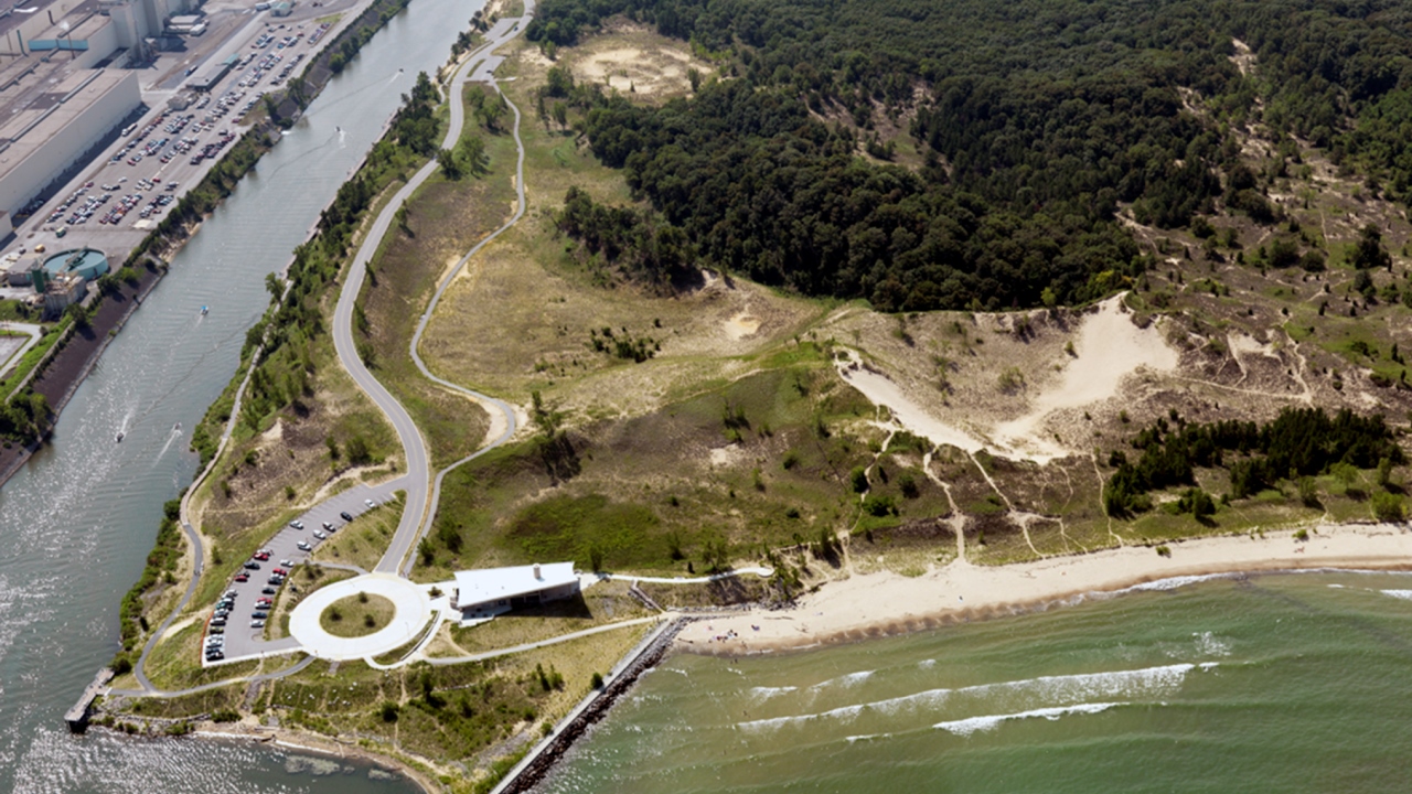 An aerial view of the Indiana Dunes National Lakeshore in Portage, Indiana. U.S. Steel's facility can be seen in the upper left corner adjacent to the tributary to Lake Michigan. (Indiana Dunes National Lakeshore/Flickr)