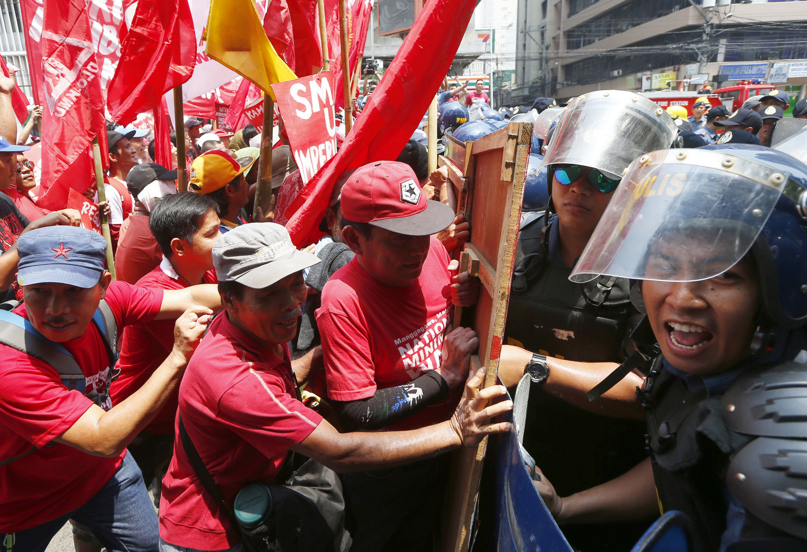 Protesters clash with riot police as they attempt to force their way closer to U.S. Embassy to mark May Day celebrations in Manila, Philippines, Monday, May 1, 2017. As in the past years, workers mark Labor Day with calls for higher wages and an end to the so-called "Endo" or contractualization. 