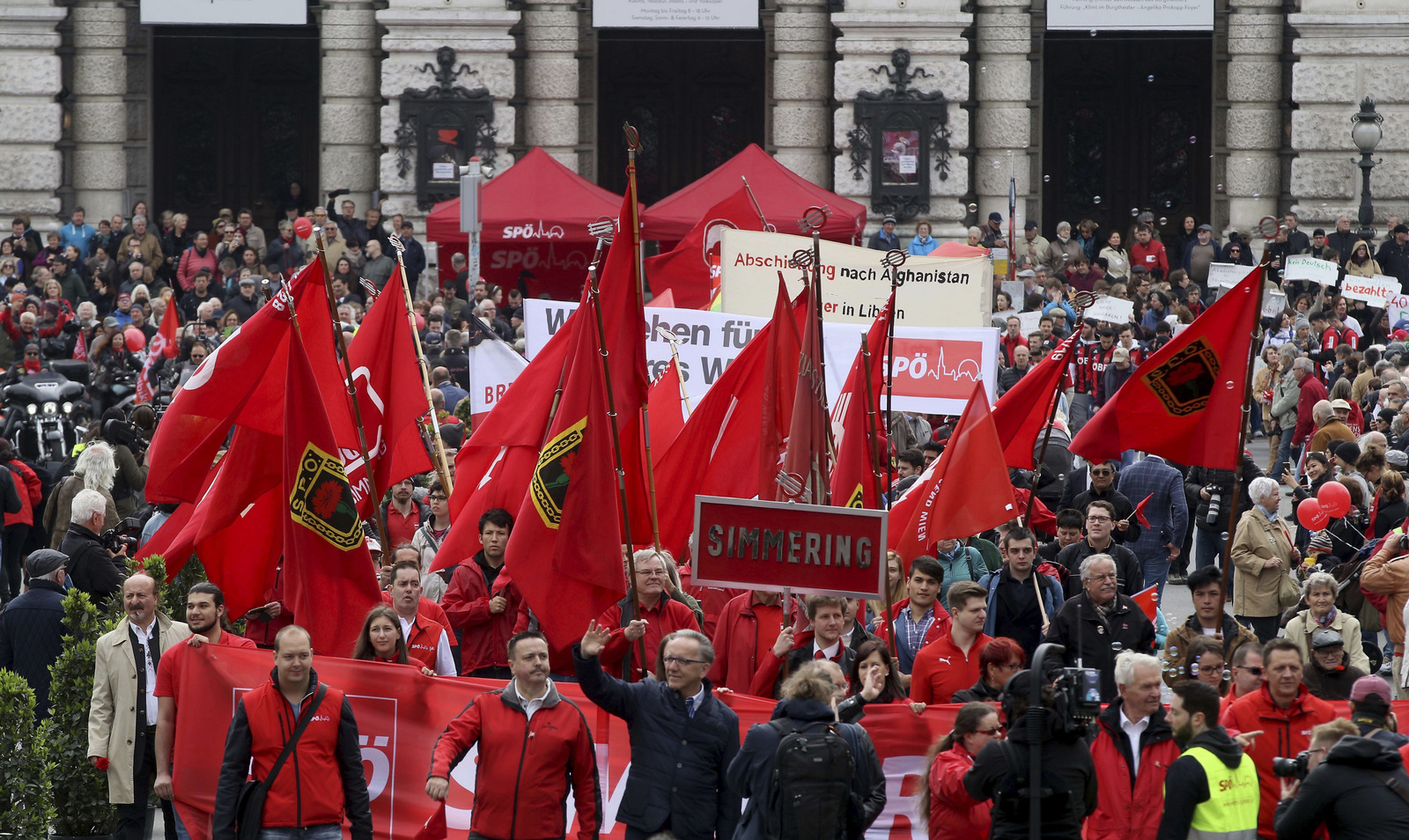 Participants of the traditional May Day celebrations, organized by the Austrian Social Democrats, SPOE, and trade unions walk with flags and banners in Vienna, Austria, Monday, May 1, 2017. 