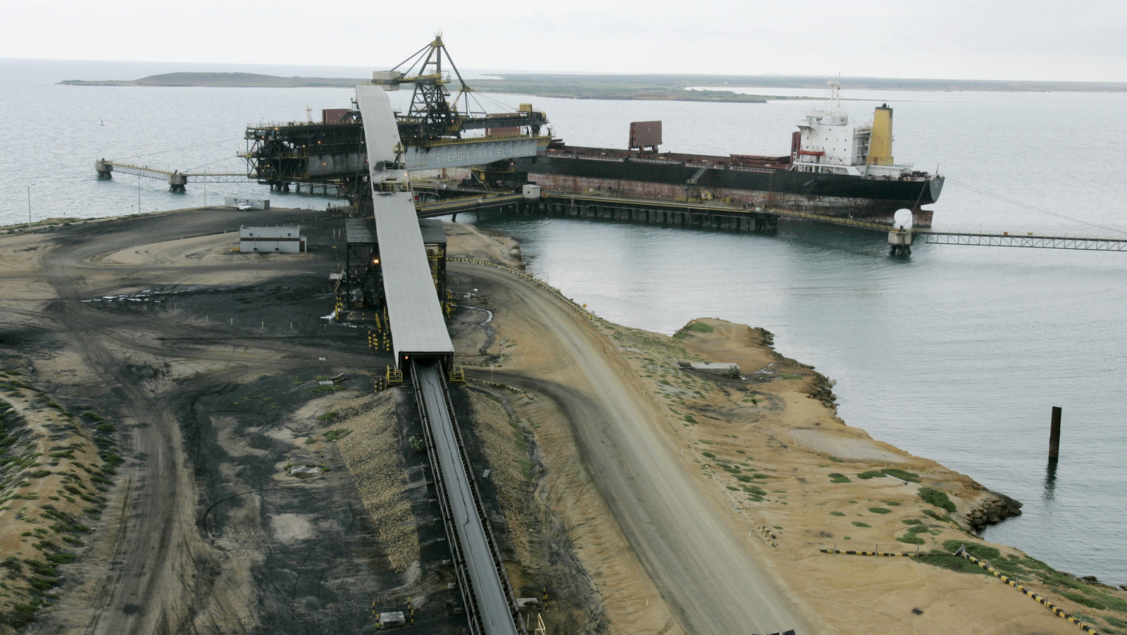 A freighter is docked at the Puerto Bolivar seaport, in the Guajira peninsula in northern Colombia. All the coal produced at Cerrejon, the world's biggest open-pit export coal mine, is shipped by train to Puerto Bolivar, where it is loaded onto freighters bound for Europe and America. (AP/Ricardo Mazalan)
