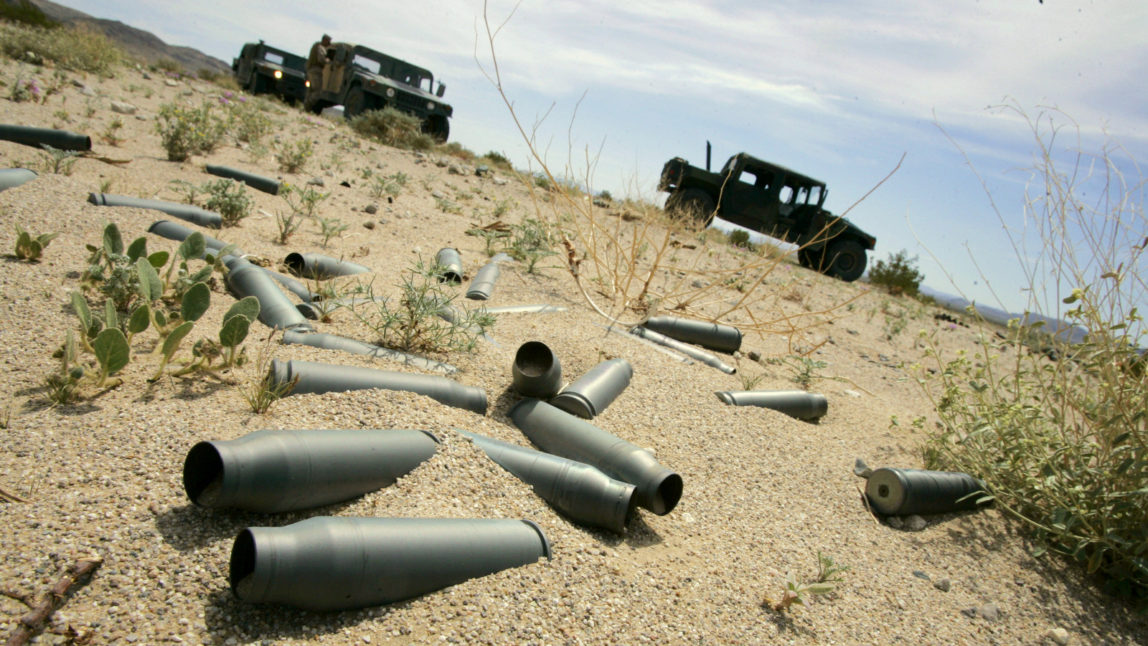 Spent shell casings from firing practice litter the desert of the U.S. Marine Corps' Air Ground Combat Center at Twentynine Palms, California. (AP/Reed Saxon)