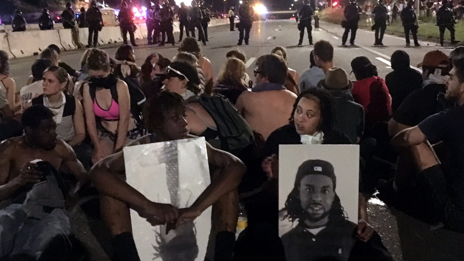 Police form a line in response to protesters who blocked a highway while rallying in response to the killing of Philando Castile, who was shot and killed by a suburban St. Paul police officer on July 6. (AP/Joe Danborn)