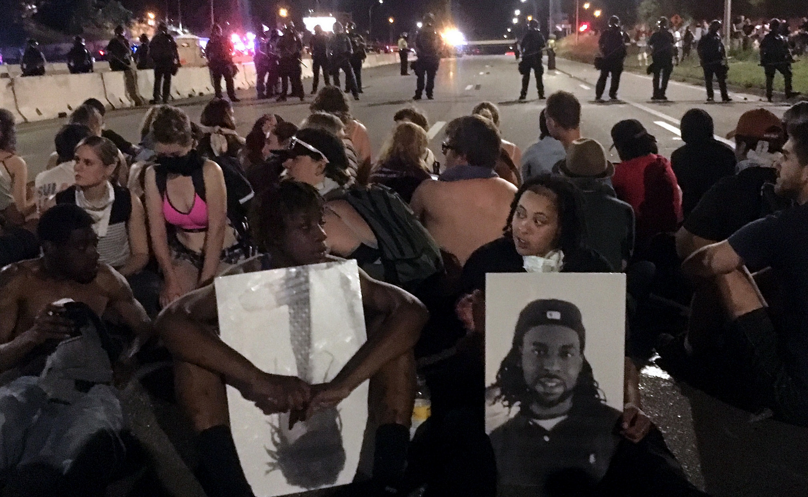 Police form a line in response to protesters who blocked a highway while rallying in response to the killing of Philando Castile, who was shot and killed by a suburban St. Paul police officer on July 6. (AP/Joe Danborn)