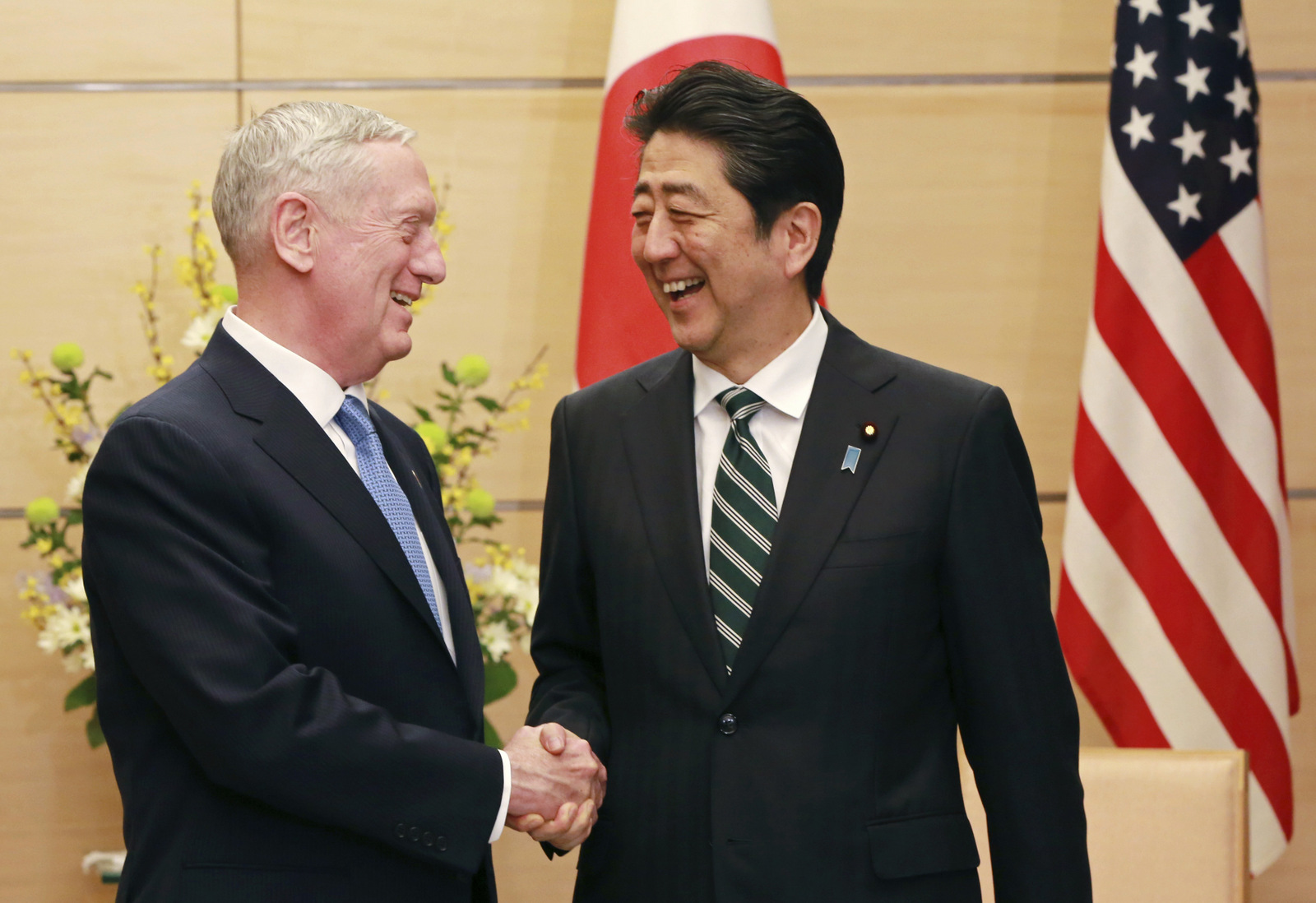 U.S. Defense Secretary Jim Mattis, left, and Japanese Prime Minister Shinzo Abe, right, shake hands at the prime minister's office in Tokyo, Friday, Feb. 3, 2017. (AP/Eugene Hoshiko)