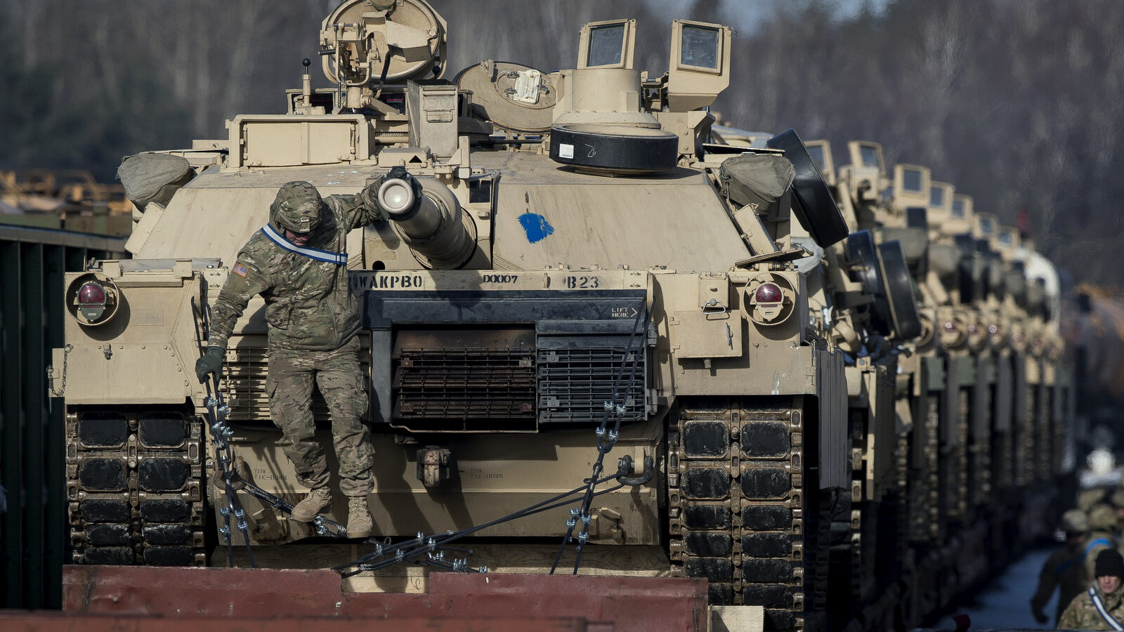 Abrams battle tanks from the US Army's 4th Infantry Division on rail cars as they arrive at the Gaiziunai railway station in Lithuania, Feb. 10, 2017.(AP/Mindaugas Kulbis)