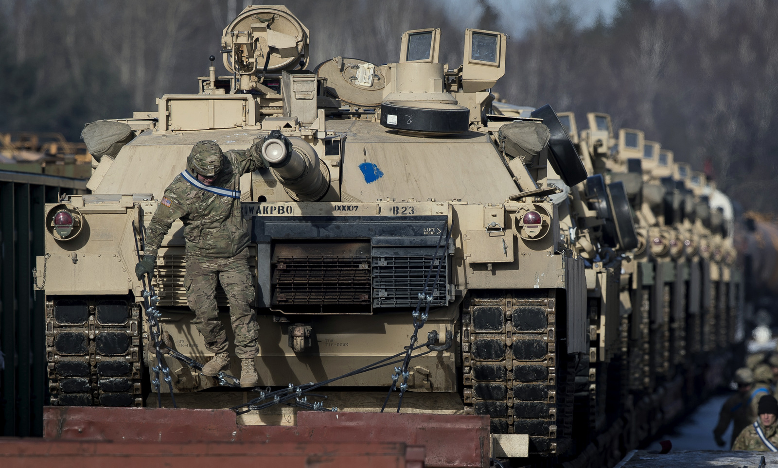 Abrams battle tanks from the US Army's 4th Infantry Division on rail cars as they arrive at the Gaiziunai railway station in Lithuania, Feb. 10, 2017.(AP/Mindaugas Kulbis)