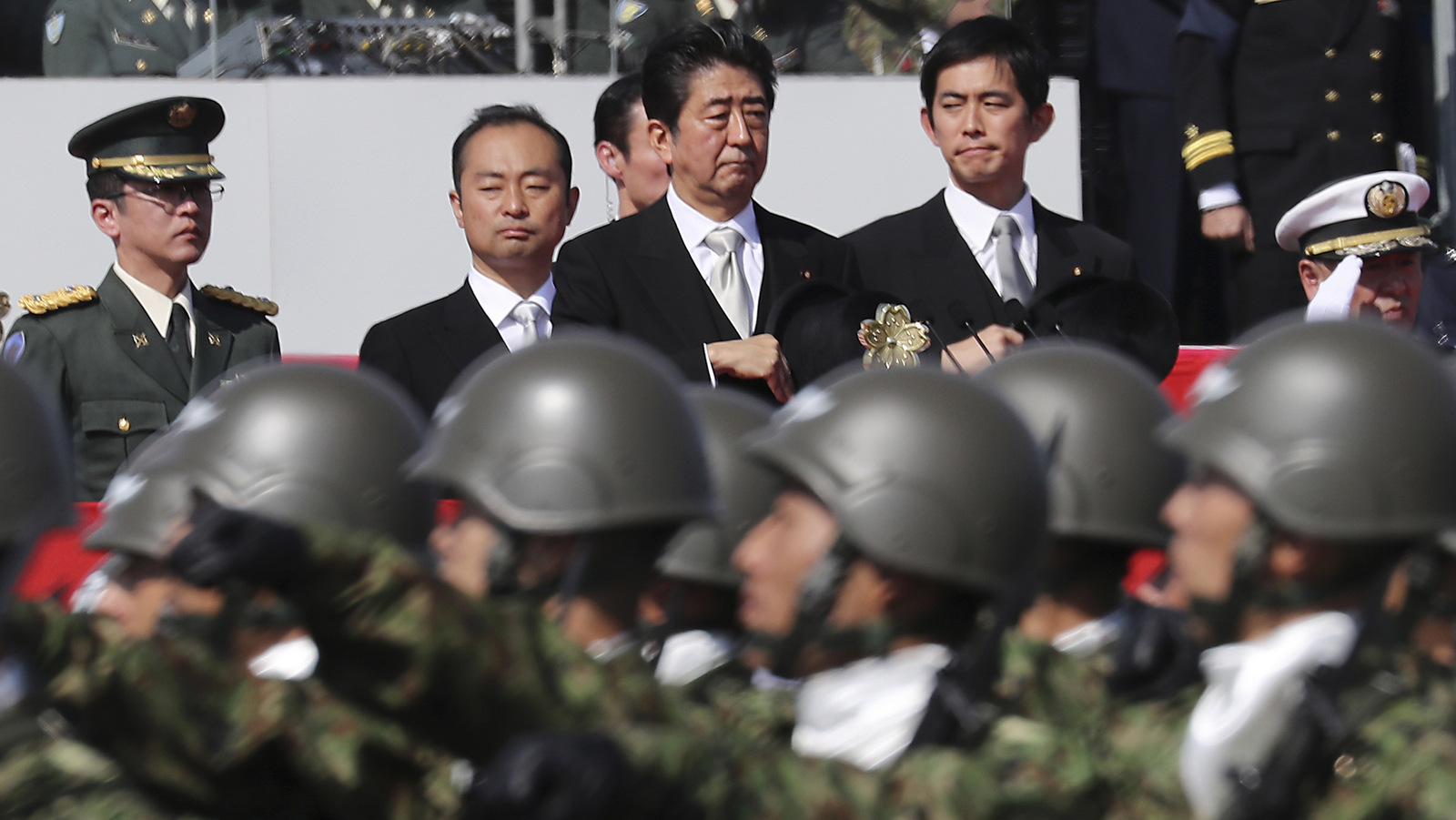  Japanese Prime Minister Shinzo Abe, center, reviews members of Japan Self-Defense Forces during a parade of the Self-Defense Forces Day at Asaka Base in Asaka, north of Tokyo. (AP/Eugene Hoshiko)