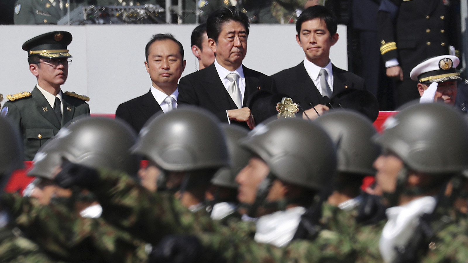 Japanese Prime Minister Shinzo Abe, center, reviews members of Japan Self-Defense Forces during a parade of the Self-Defense Forces Day at Asaka Base in Asaka, north of Tokyo. (AP/Eugene Hoshiko)