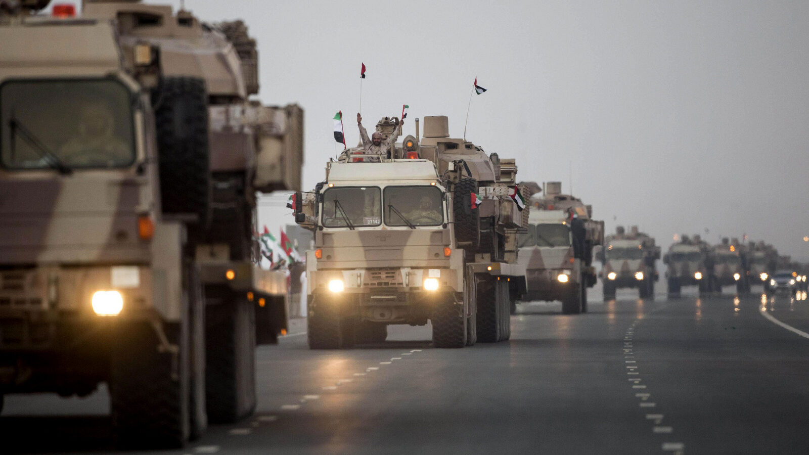 A convoy of UAE military vehicles and personnel travels from Al Hamra Military Base to Zayed Military City, marking the return of the first batch of UAE Armed Forces military personnel from Yemen, in Abu Dhabi, United Arab Emirates. (WAM via AP)