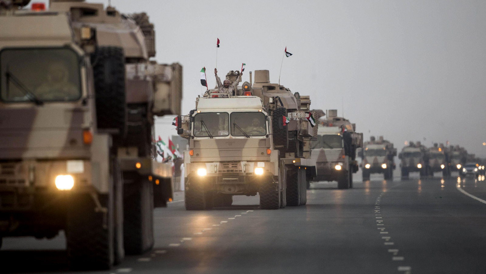 A convoy of UAE military vehicles and personnel travels from Al Hamra Military Base to Zayed Military City, marking the return of the first batch of UAE Armed Forces military personnel from Yemen, in Abu Dhabi, United Arab Emirates. (WAM via AP)