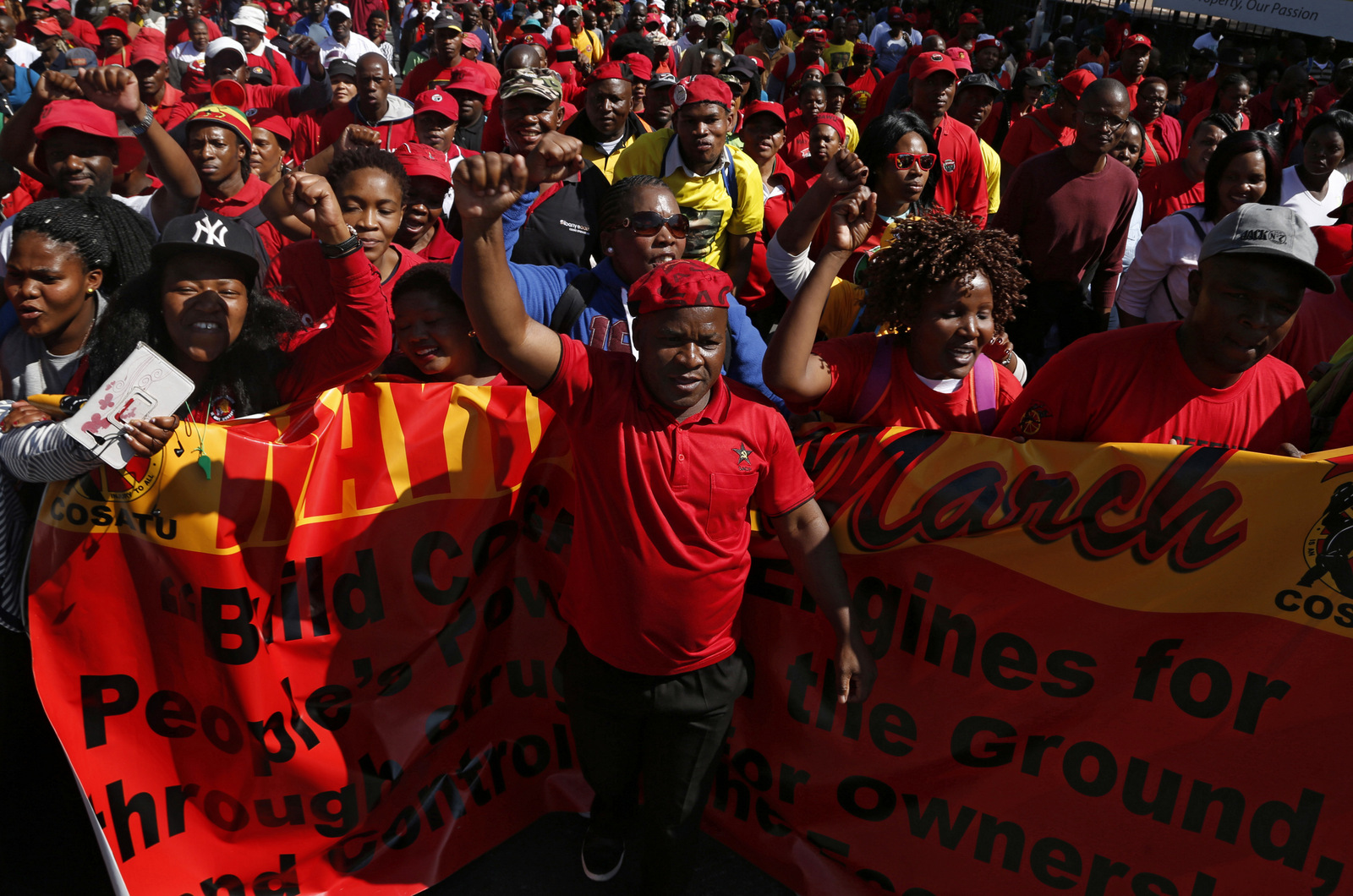 Workers take part in a May Day march to the Johannesburg Stock Exchange building on Monday, May 1, 2017. A speech by President Jacob Zuma to workers at a rally was cancelled in Bloemfontein as Zuma was heckled by some members during the gathering singing that he should step down. (AP/Denis Farrell)