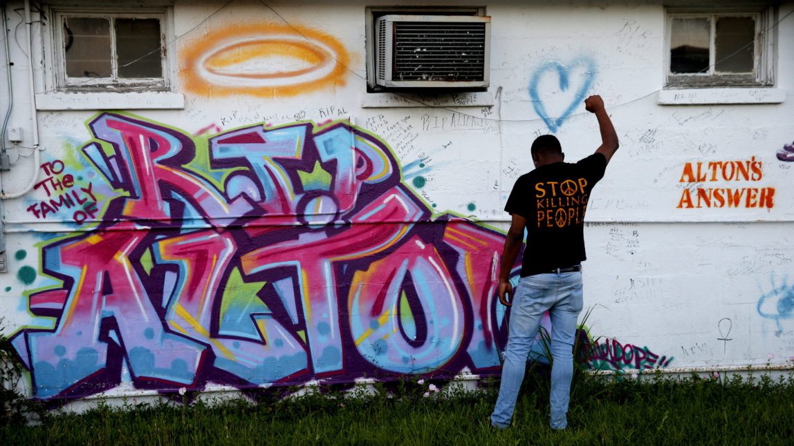 Damon Brumfield, a student at Southern University of Baton Rouge, poses while his friends take photos, in front of a mural honoring Alton Sterling, outside the Triple S Food Mart in Baton Rouge, La., Tuesday, May 2, 2017. The U.S. Justice Department has decided not to charge two white Baton Rouge police officers in the death of Sterling, whose death was captured on cell phone video, fueling protests in Louisiana's capital and beyond. (AP/Gerald Herbert)