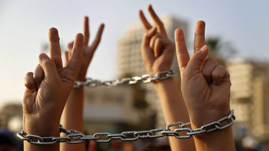 Palestinian boys raise up their hands with chains, during a protest to show their solidarity with hunger striking Palestinian prisoners in Israeli jails, who have been on an open-ended hunger strike for the past 18 days, in Beirut, Lebanon, Thursday, May 4, 2017. (AP/Hussein Malla)