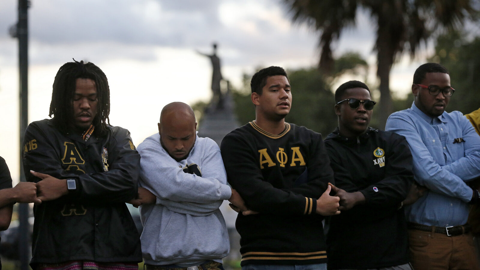 Graduate members of Alpha Phi Alpha Fraternity pray during a "social action prayer vigil" across the street from the Jefferson Davis monument in New Orleans, Thursday, May 4, 2017. The group supports the removal of confederate monuments, and New Orleans Mayor Mitch Landrieu has removed one already and vowed to remove several more, one of which is the Jefferson Davis monument. (AP/Gerald Herbert)