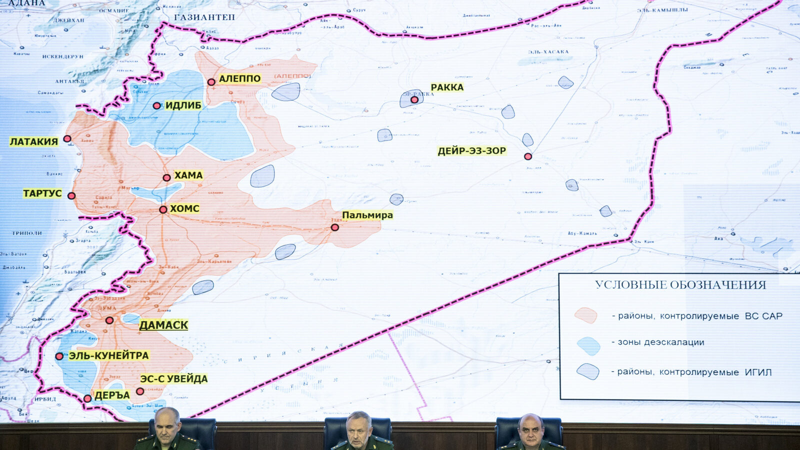 Russian generals attend a briefing in the Defense Ministry in Moscow, Russia, Friday, May 5, 2017. Russia's military says the agreement setting up four de-escalation zones in Syria will go into effect at midnight. The military also says the deal, which was signed by Russia, Iran and Turkey in Kazakhstan the day before, could be extended to more areas of the war-torn country. The sign on top of the map reads Syrian safe zones. (AP/Pavel Golovkin)