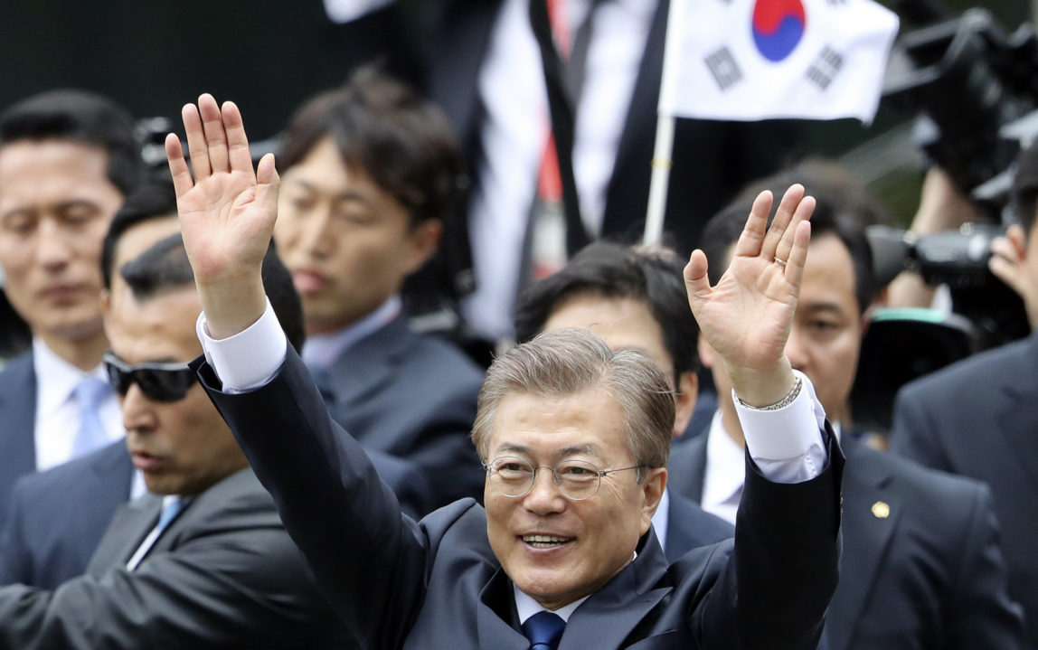 South Korea's new President Moon Jae-in waves to supporters upon his arrival outside the presidential Blue House in Seoul, South Korea, May 10, 2017, (AP/Lee Jin-man)