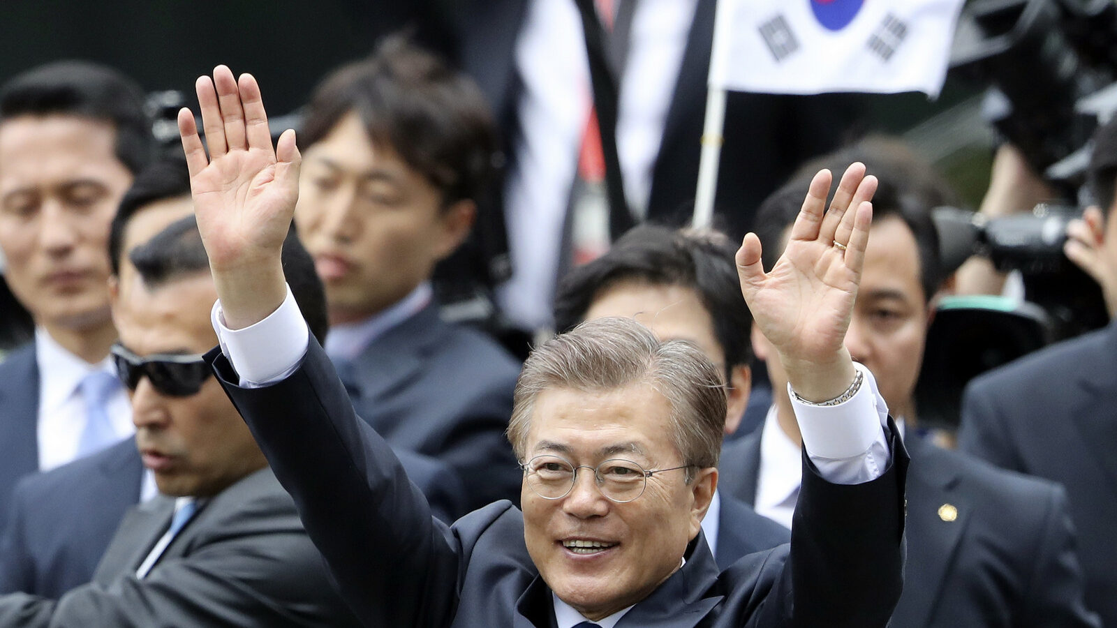 South Korea's new President Moon Jae-in waves to supporters upon his arrival outside the presidential Blue House in Seoul, South Korea, May 10, 2017, (AP/Lee Jin-man)