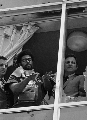Sen. Walter Mondale, D-Minn.,left, and Sen. Birch Bayh, D-Ind., right, looking from shattered windows on to the area where two people were shot to death at what is now Jackson State University in Jackson, Miss. May 20, 1970. (AP Photo)
