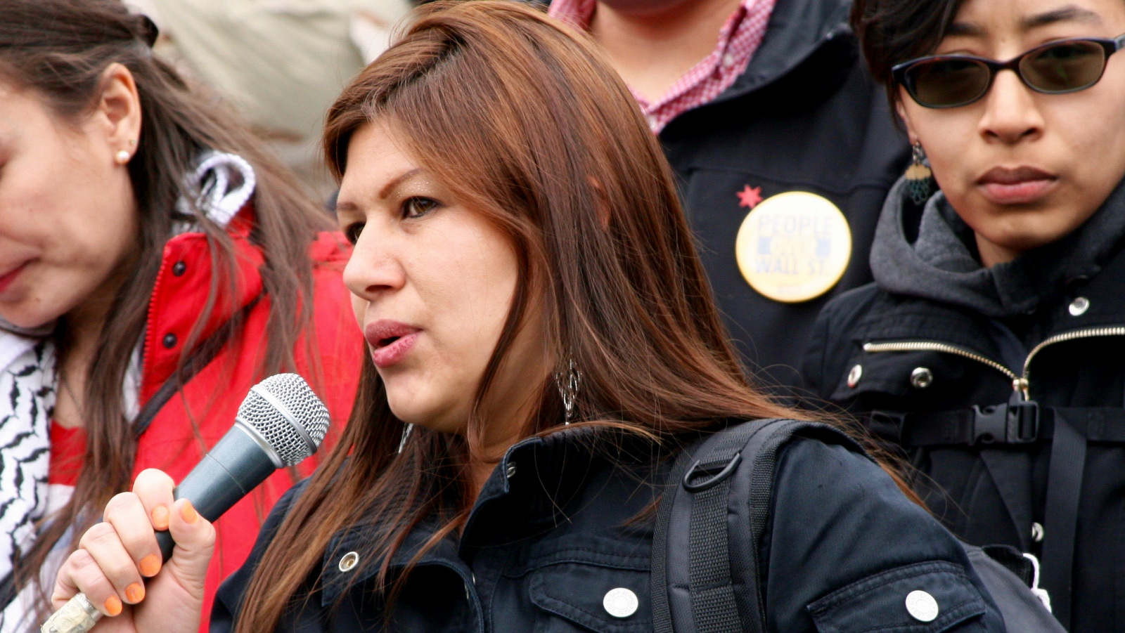 Celene Adame, wife of Wilmer Catalan-Ramirez, speaks about her husband’s arrest by Immigration and Customs Enforcement at a May Day rally at Chicago’s Union Park. (Photo: Jeanne Kuang/Injustice Watch)