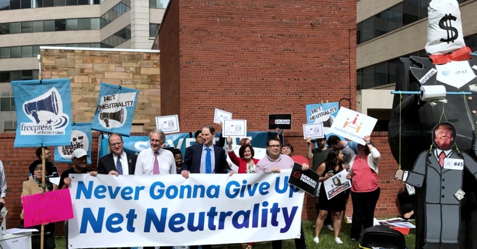 Rep. Jared Polis (D-Colo.), Sen. Ed Markey (D-Mass.), and Sen. Ron Wyden (D-Ore.) hold up a banner at Thursday's rally for net neutrality in Washington, D.C. (Photo: Ron Wyden/Twitter)