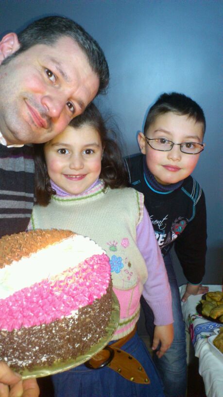 The Hajjo family celebrates Abed Hajjo's birthday in their Aleppo home, 2012. Taken by his late wife Camilia, the photo shows Abed and his children Jameel and Julie.