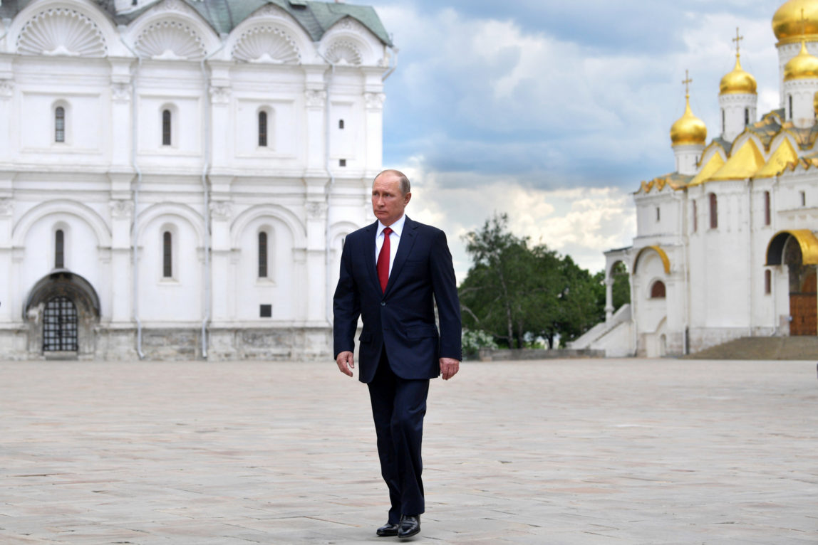 Russian President Vladimir Putin walks along the Cathedral Square of the Kremlin, to take part in a holiday reception in Moscow, Monday, June 12, 2017. (Alexei Druzhinin/Sputnik)