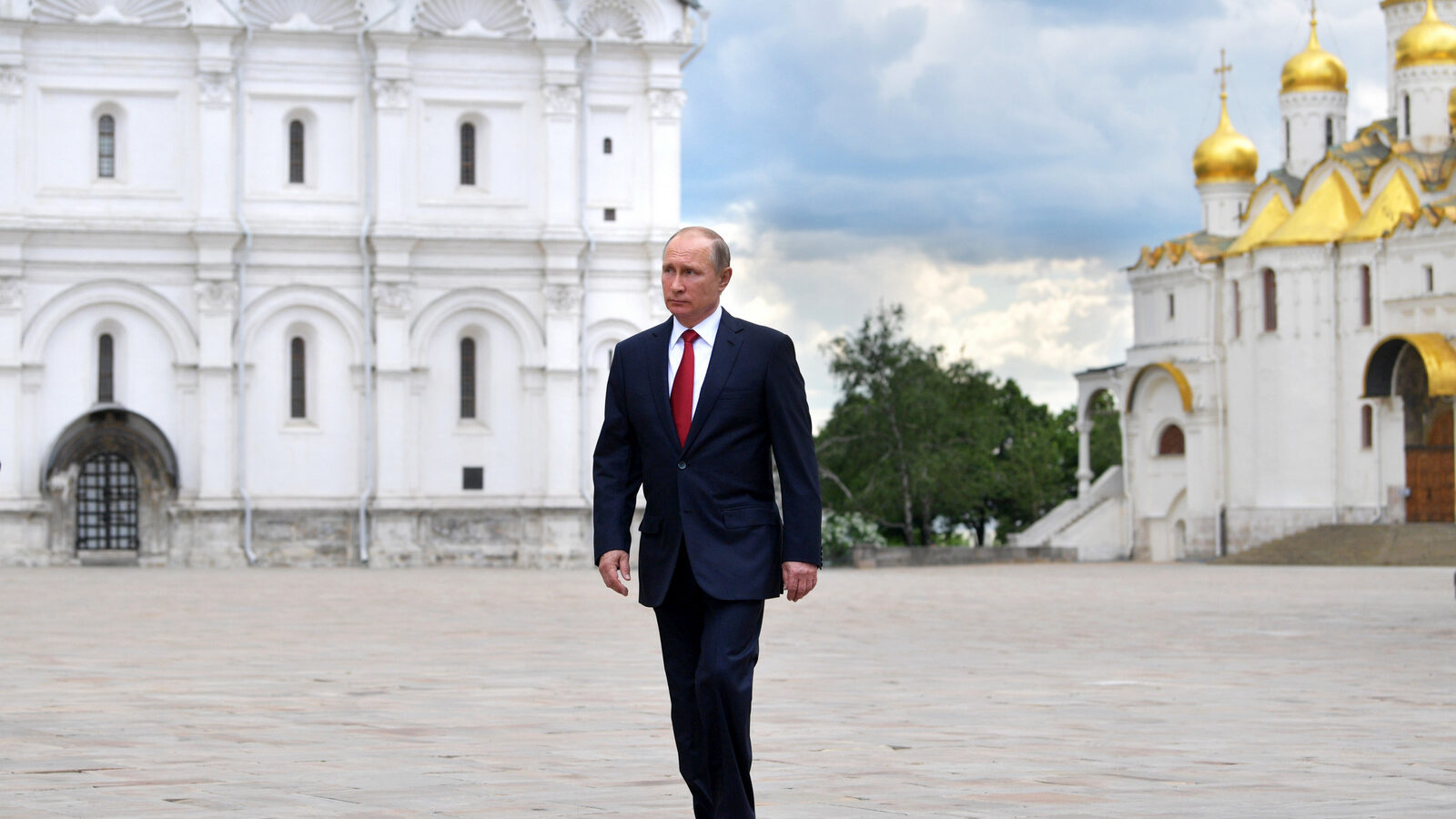 Russian President Vladimir Putin walks along the Cathedral Square of the Kremlin, to take part in a holiday reception in Moscow, Monday, June 12, 2017. (Alexei Druzhinin/Sputnik)