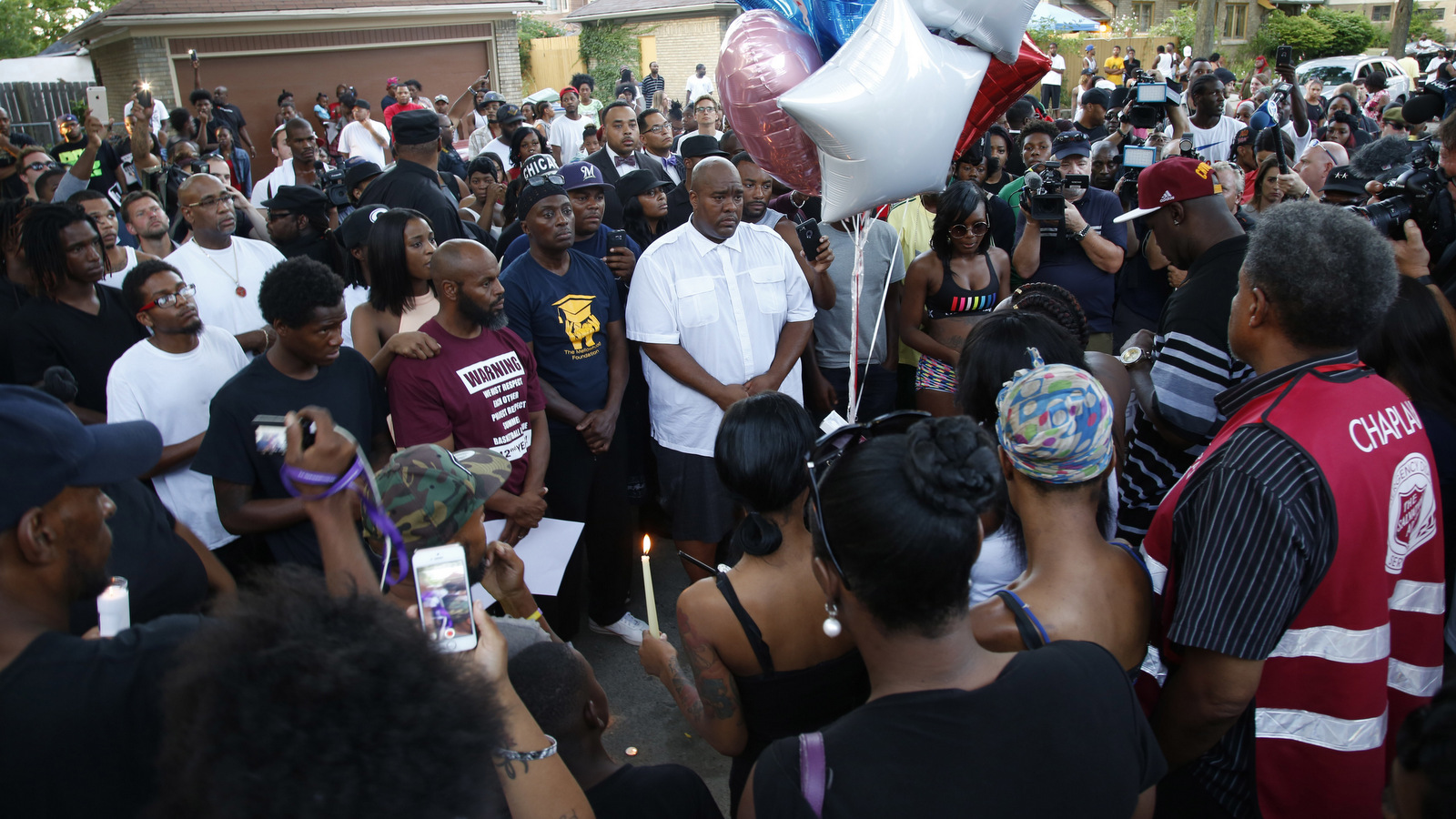 Family members of Sylville Smith and others gather where he was shot and killed by Milwaukee police in Milwaukee, Sunday, Aug. 14, 2016. (AP/Jeffrey Phelps)