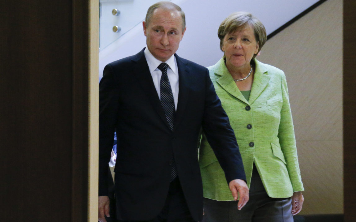 Russian President Vladimir Putin, left, and German Chancellor Angela Merkel arrive for talks at Putin's residence in the Russian Black Sea resort of Sochi, Russia, Tuesday, May 2, 2017. (AP/Alexander Zemlianichenko)