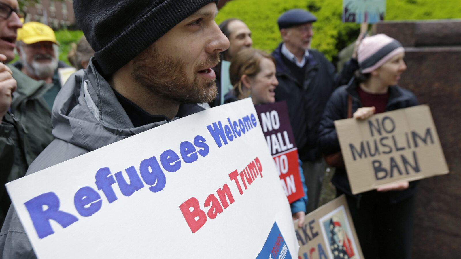 Miles Treakle, left, of Seattle, holds a sign that reads "Refugees Welcome Ban Trump," as he protests against President Donald Trump's revised travel ban, May 15, 2017, outside a federal courthouse in Seattle. (AP/Ted S. Warren)