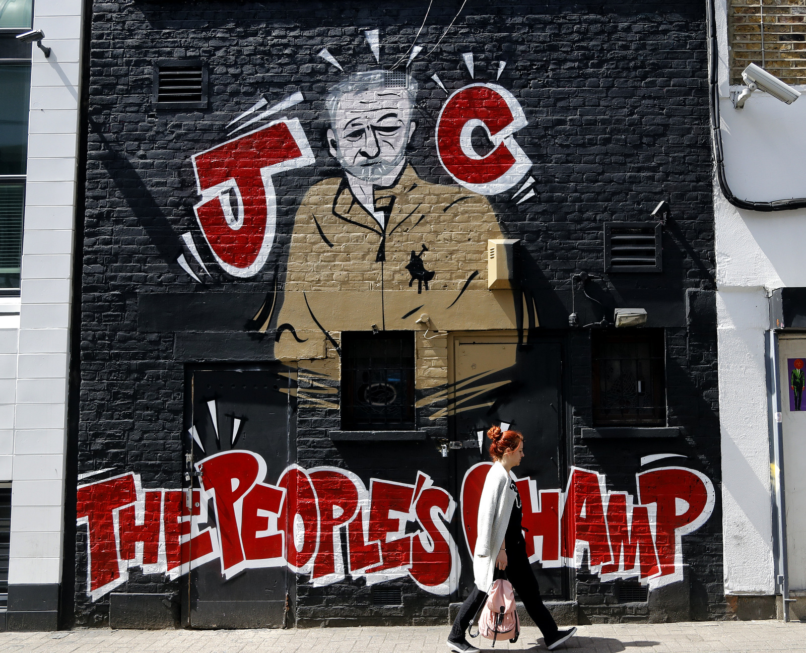 A woman walks past a Jeremy Corbyn mural in Camden, London on, June 1, 2017. (AP/Frank Augstein)