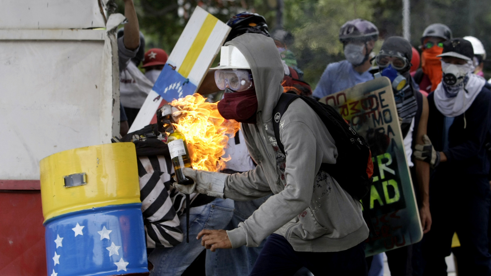 A demonstrators readies a gas bomb as he prepares to throw it at the police during clashes between police and anti-government demonstrators in Caracas, Venezuela, June 7, 2017. The clashes have claimed more than 60 lives as they enter their third month. (AP/Fernando Llano)