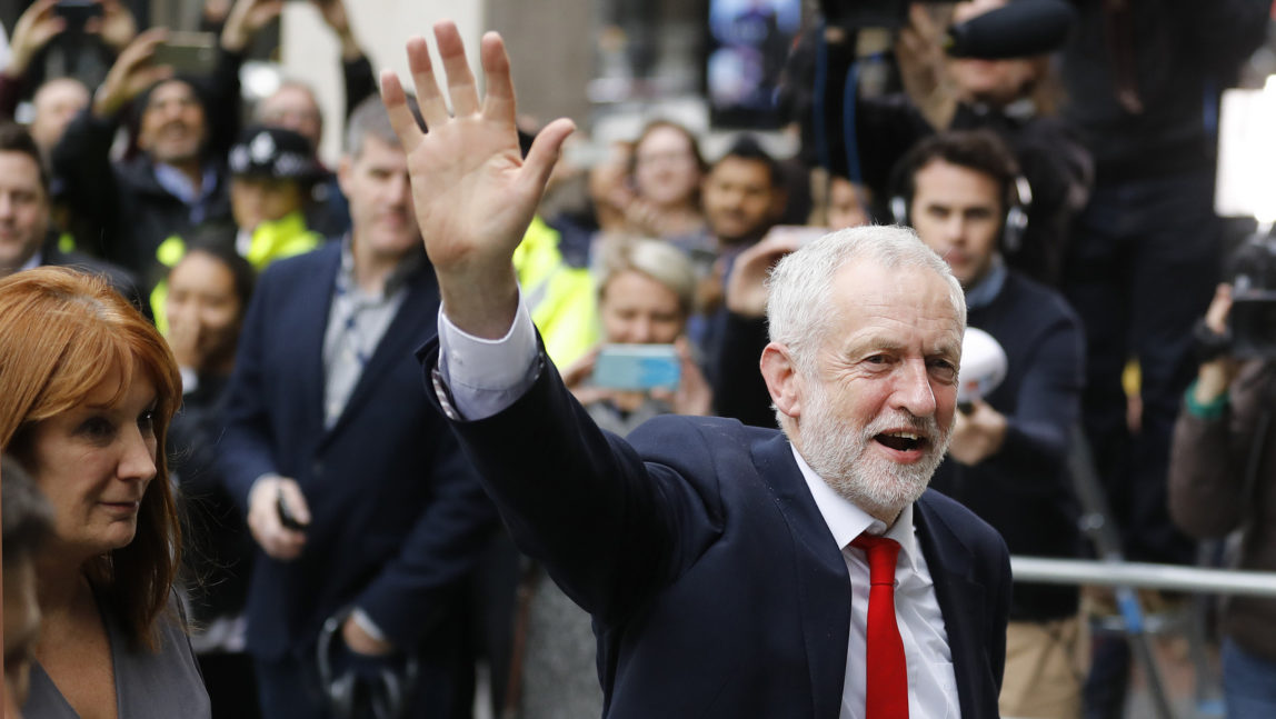 Britain's Labour party leader Jeremy Corbyn waves as he arrives at Labour party headquarters in London, Friday, June 9, 2017. British Prime Minister Theresa May's gamble in calling an early election backfired spectacularly, as her Conservative Party lost its majority in Parliament and pressure mounted on her Friday to resign. (AP/Frank Augstein)