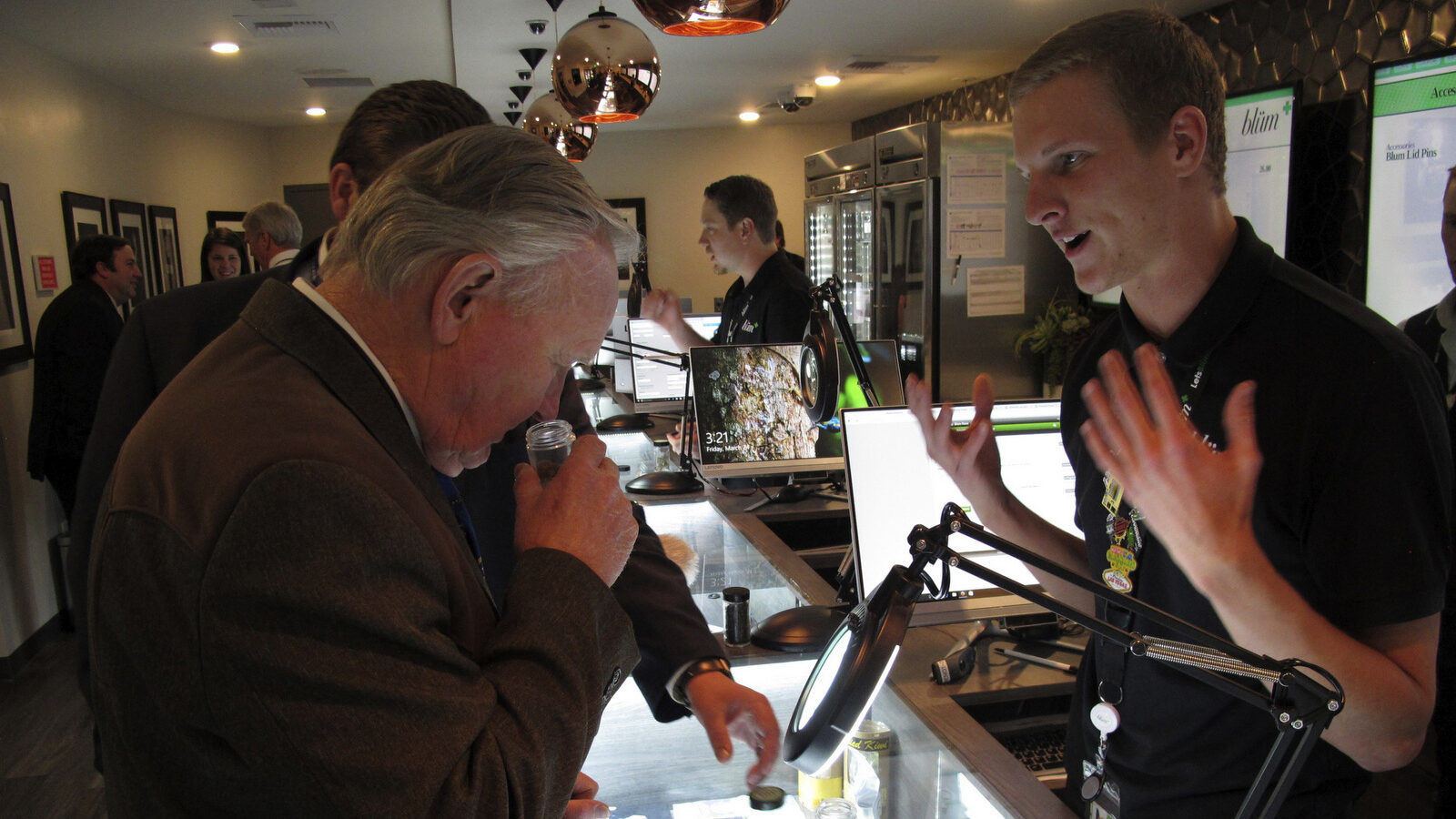 Nevada state Sen. Don Gustavson, R-Sparks, smells a sample of marijuana as Christopher Price, a ''budtender'' at the Blum medical marijuana dispensary in Reno, Nev. March 24, 2017. (AP/Scott Sonner)