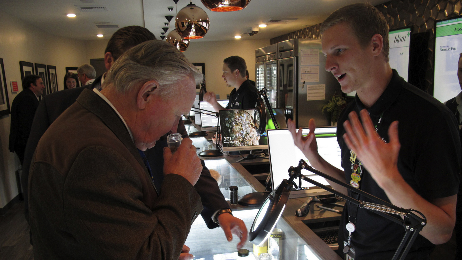 Nevada state Sen. Don Gustavson, R-Sparks, smells a sample of marijuana as Christopher Price, a ''budtender'' at the Blum medical marijuana dispensary in Reno, Nev. March 24, 2017. (AP/Scott Sonner)