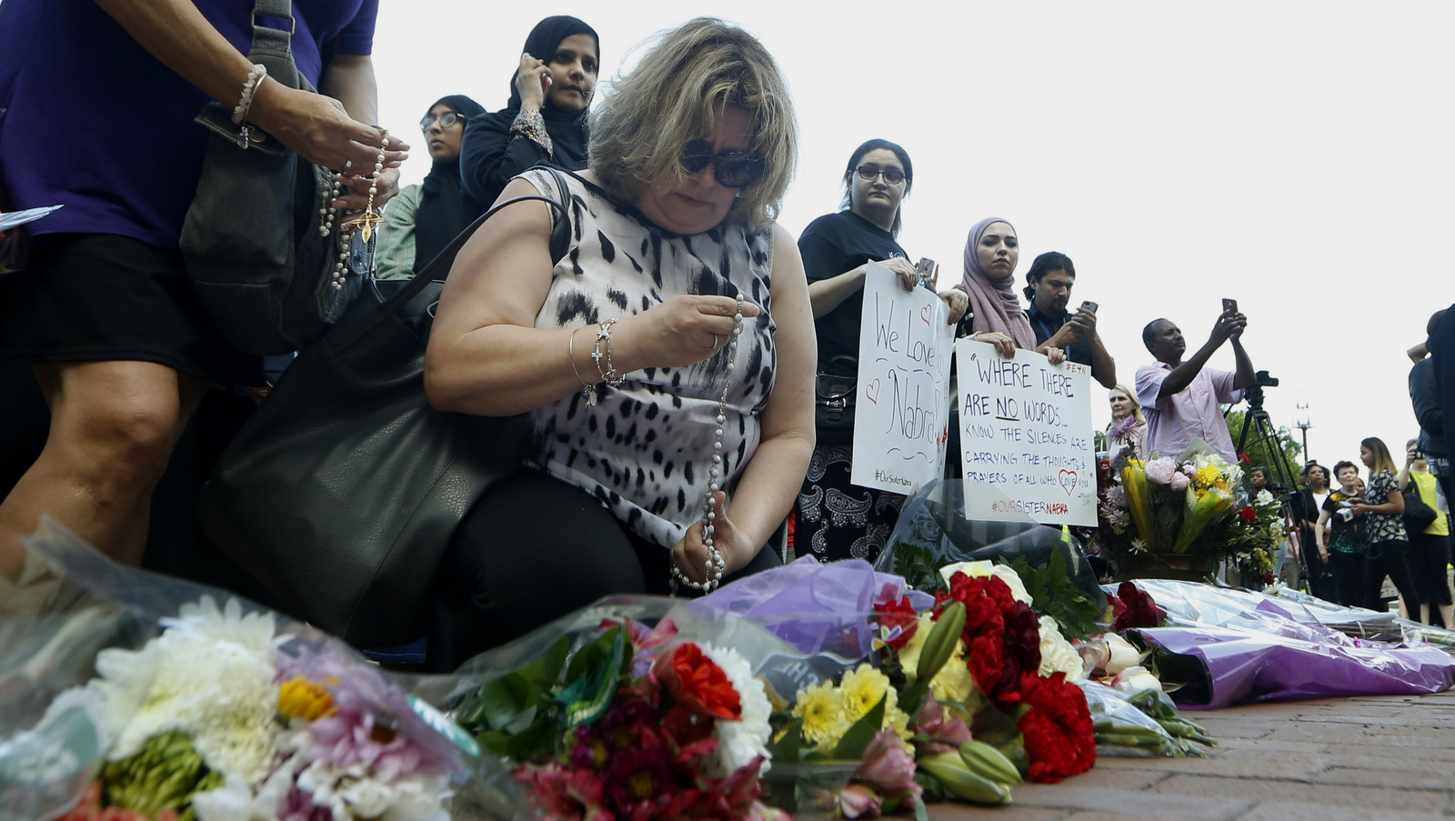 Supporters of Nabra Hassanen, who was killed over the weekend, kneel and pray with a rosary prior to the start of a vigil in honor of Nabar on, June 21, 2017, in Reston, Va. About 5,000 mourners attended Wednesday's funeral of Nabre, a Muslim girl whose beating death, blamed by police on a motorist's road rage, has some people in her community fearing for their safety. (AP/Steve Helber)