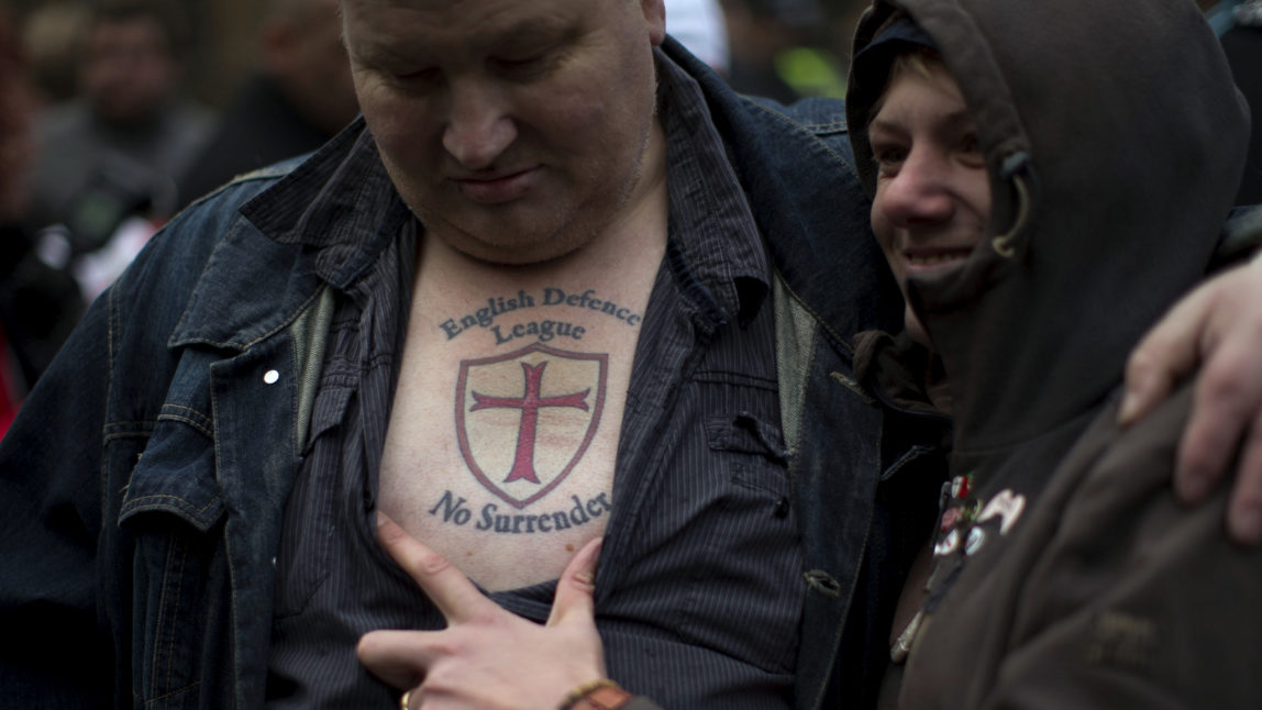 A member of the English Defence League far right group has his tattoo displayed during a protest outside the Houses of Parliament in London, Oct. 27, 2012. (AP/Matt Dunham)