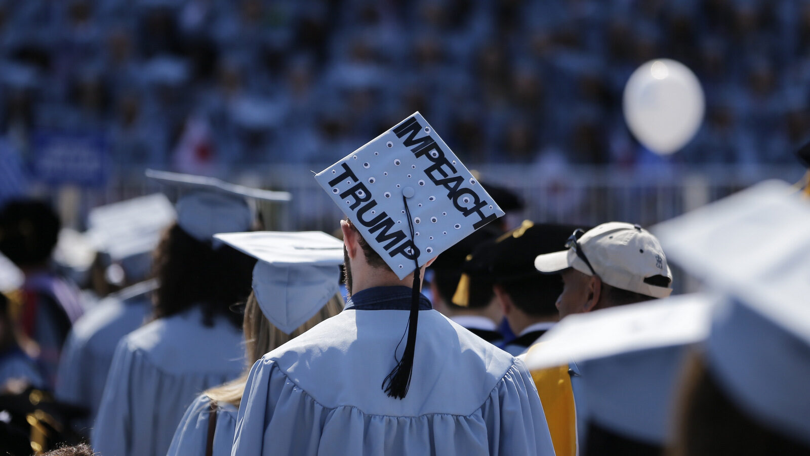 A student wears a hat reading "Impeach Trump" during a graduation ceremony at Columbia University in New York, Wednesday, May 17, 2017. (AP/Seth Wenig)