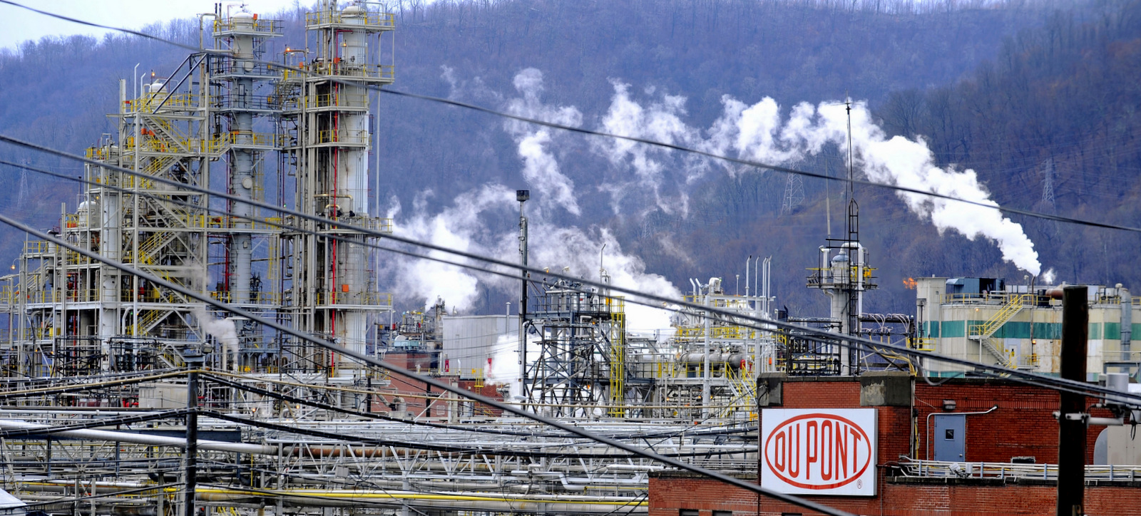 White smoke hovers over a DuPont chemical plant in Belle, W.Va. DuPont - a chemical company with a long history of endangering public health - is being sued by 13 people in Louisiana over emissions from one of its plants. (AP/Jeff Gentner)