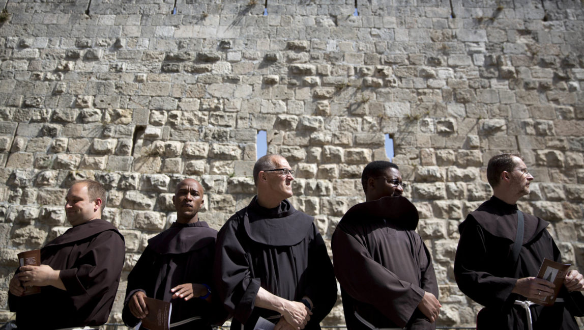 Catholic priests wait for the start of the procession in Jerusalem's Old City, June 6, 2016. (AP/Ariel Schalit)