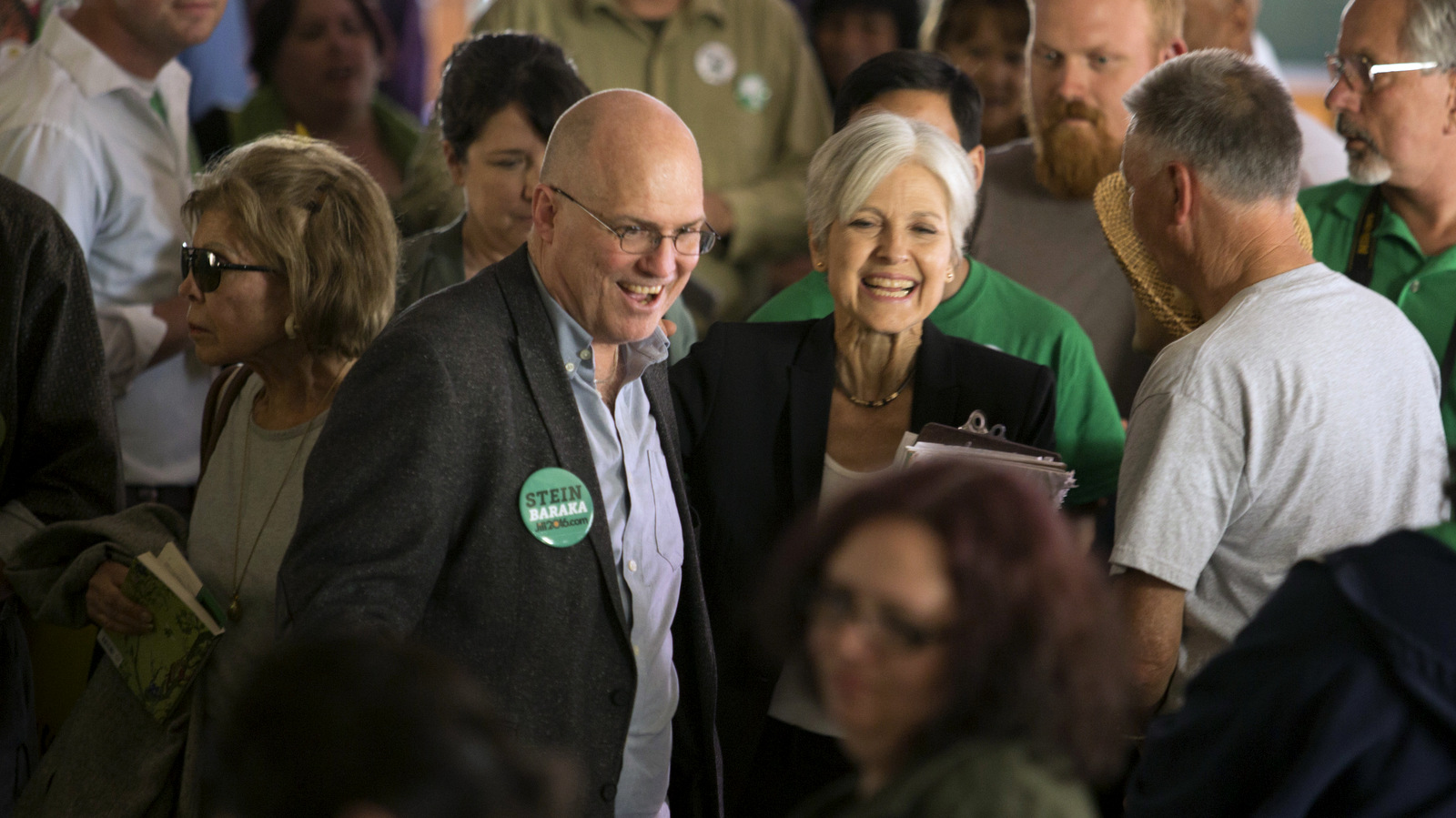 Accompanied by 2004 presidential candidate David Cobb, left, Green party presidential hopeful Jill Stein meets her supporters during a campaign stop at Humanist Hall in Oakland, Calif. Oct. 6, 2016. (AP/D. Ross Cameron)