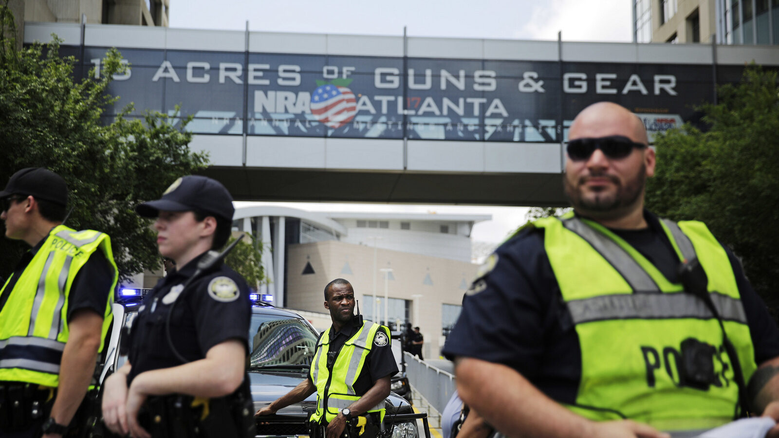 Police stand watch during a protest across the street from the National Rifle Association's annual convention where Donald Trump was scheduled to speak in Atlanta, April 28, 2017. (AP/David Goldman)