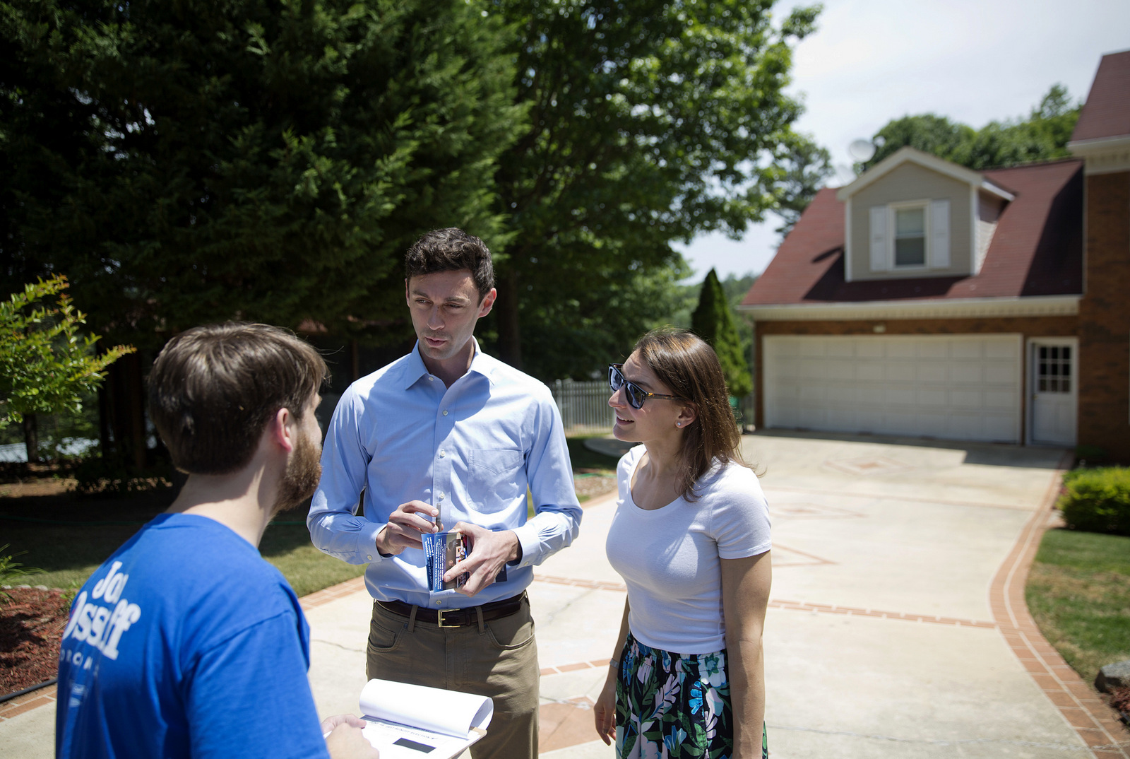 Jon Ossoff and fiancee Alisha Kramer, talk with organizer Eliot Beckham while campaigning in Sandy Springs, Ga., May 11, 2017. (AP/David Goldman)