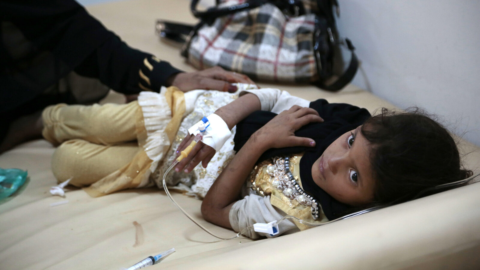 A girl is treated for a suspected cholera infection at a hospital in Sanaa, Yemen. The World Health Organization says a rapidly spreading cholera outbreak in Yemen has claimed thousands of lives since April and is suspected of affecting 246,000 people. (AP/Hani Mohammed)