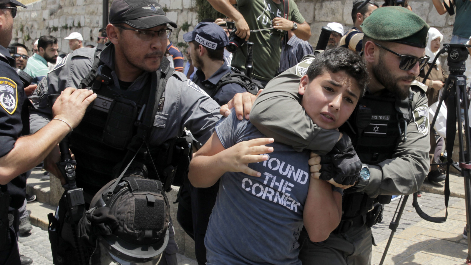 Israeli police place a Palestinian boy in a chokehold in Jerusalem's Old City, July 17, 2017. Muslims boycotted the Jerusalem holy site in a gesture of protest after Israel denied access to Muslims to Islam's second holiest site. (AP/Mahmoud Illean)