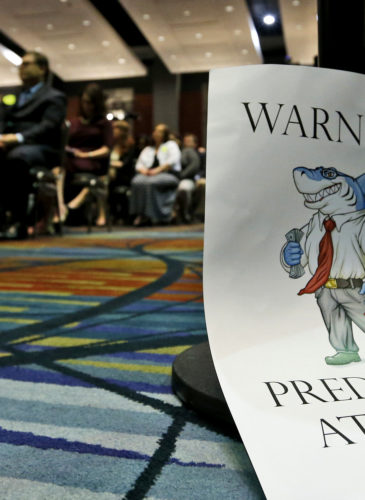 A sign leans against a chair during a speech by Consumer Financial Protection Bureau Director Richard Cordray, in Richmond, Va., March 26, 2015. (AP/Steve Helber)
