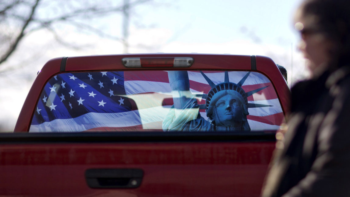 A pickup truck with a rear window decorated in the theme of the American flag and Statue of Liberty, sits in the parking lot in Manchester, N.H. (AP/David Goldman)