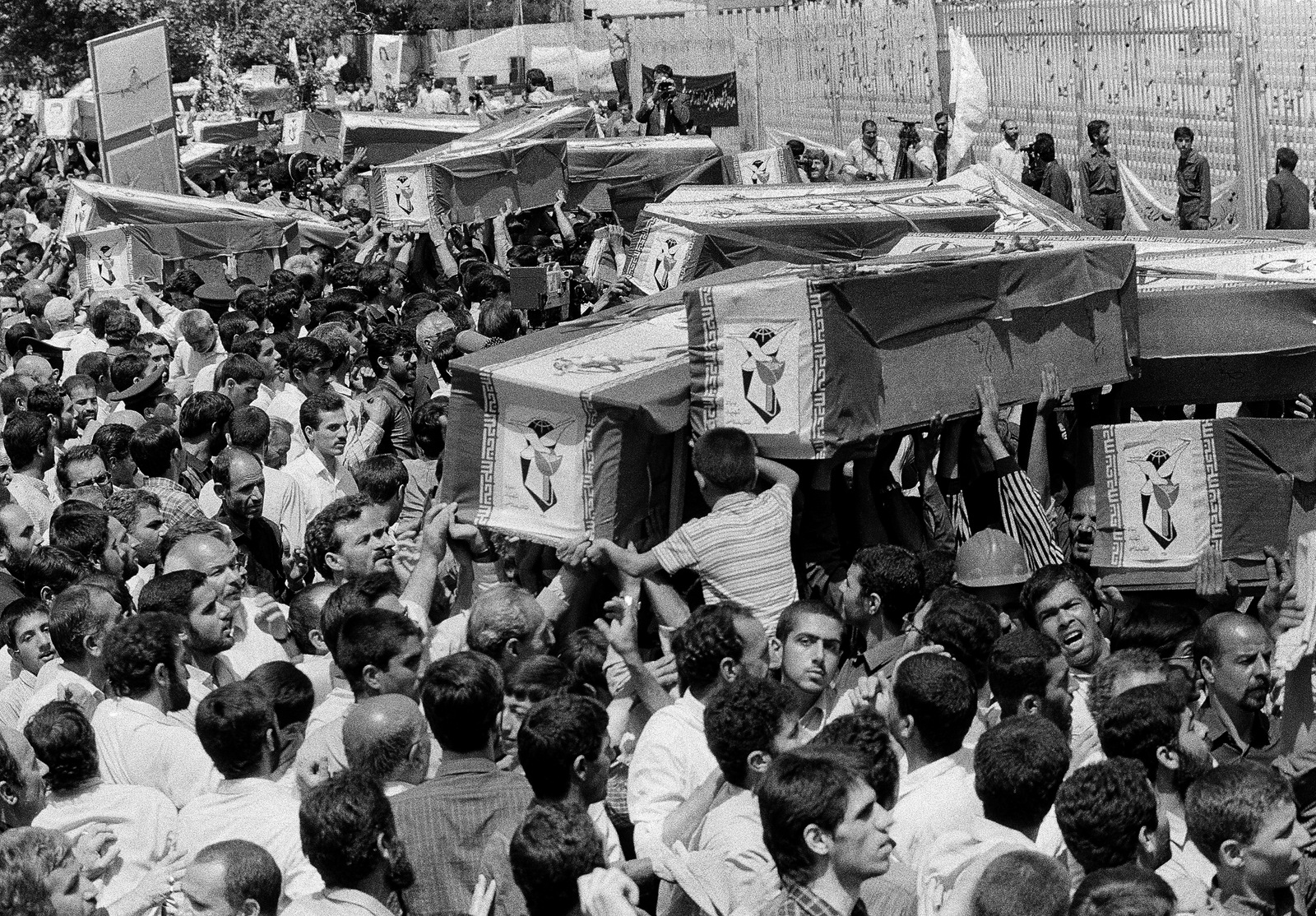 Mourners carry coffins through the streets of Tehran during a mass funeral for the victims aboard Iran Air Flight 655, which was shot down by the USS Vincennes in the Persian Gulf, July 7, 1988. Iran claims the shooting down of a passenger plane was act of cold blooded murder, the U.S. claims it was accidental. (AP Photo)