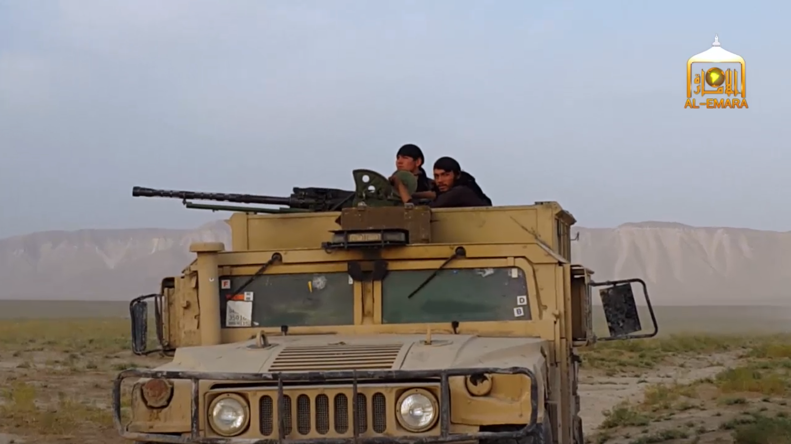 Members of the Afghan Taliban atop a captured Humvee with what appears to be an anti-aircraft weapon.
